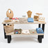 Presentatietafel winkel met wit gebeitste houten bladen en zwart stalen onderstel voor een stijlvolle presentatie van kleding en sieraden.
